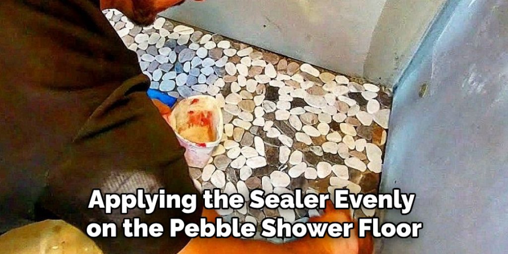 Applying the Sealer Evenly on the Pebble Shower Floor